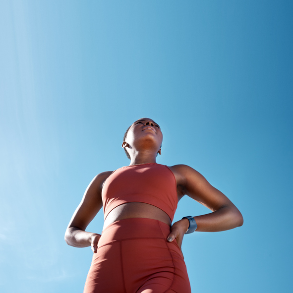 Low angle, sports fitness and black woman outdoor